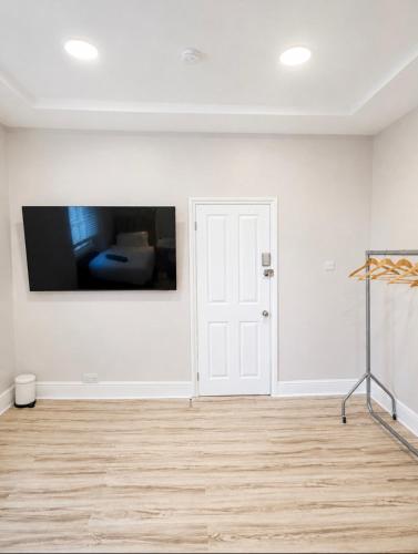 a white room with a television on a wall at Central Room to Rent in Plymouth