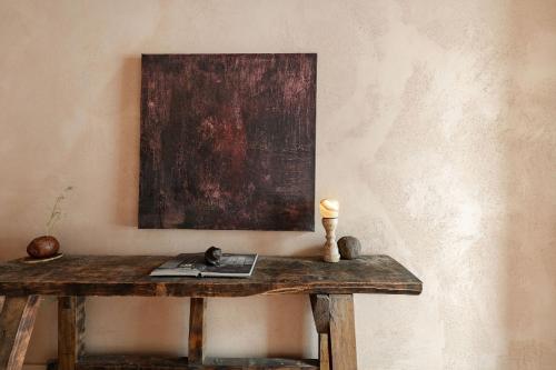a wooden table in a room with a painting on the wall at Boutique Hotel Verne Dreams in Ghent