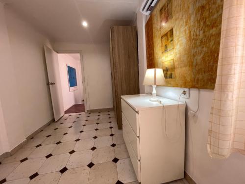 a room with a refrigerator and a hallway at Apartamento CASA EL MORABITO in Puente Genil