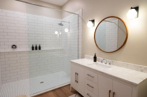 a white bathroom with a sink and a mirror at The Cove Inn in Westport