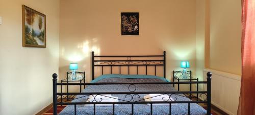 a bedroom with a bed with two lamps on it at Irida Suite in Salamina