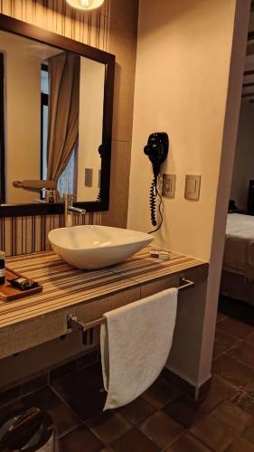 a bathroom with a sink and a mirror on a counter at Casa Moseua Hotel Boutique de Autor in Querétaro