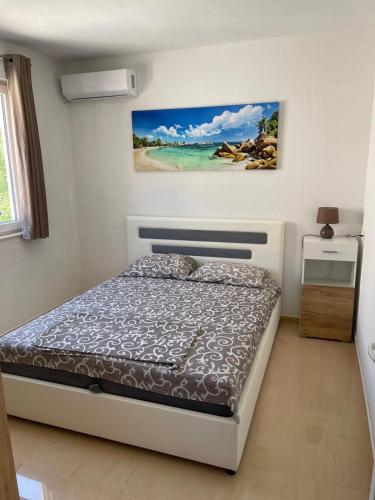 a bedroom with a bed and a painting on the wall at Apartment with pool Tomic Boka Bay in Herceg-Novi