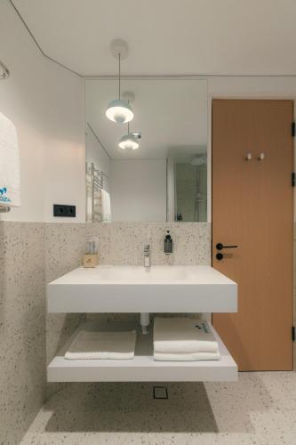 a bathroom with a sink and a mirror at Proza Hotel & Restaurant in Kutaisi