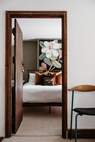 a mirror in front of a bedroom with a bed at Staneve Cottage in Docking
