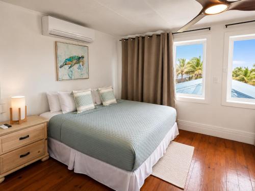 a bedroom with a bed and a window at Solea by The Sea in Roatán