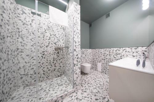 a bathroom with a shower with a toilet and a sink at Slawkowska No 6 Residence in Krakow