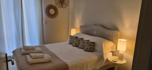 a bedroom with a bed with two pillows on it at Lilli's House in Kassiopi