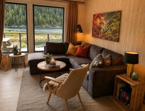 a living room with a couch and a table at Peaceful lakefront cabin in Tjaldal