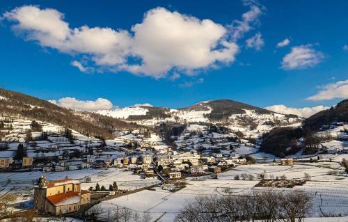 a small town covered in snow on a mountain at Estudio con Rincón de Cortesía Pusantenea in Berástegui