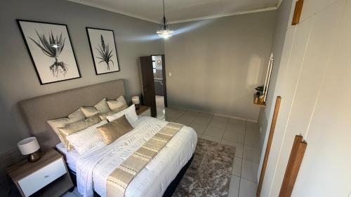 a bedroom with a large bed in a room at SiwelaNest in Mbabane