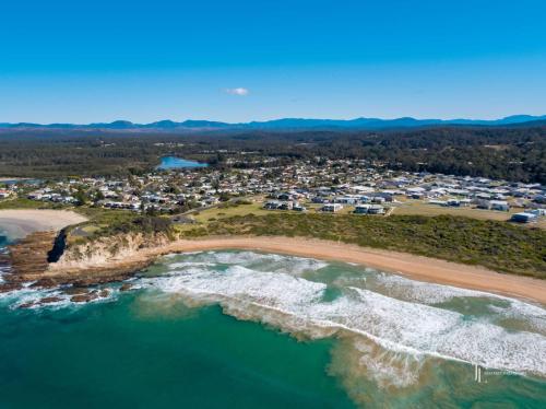 an aerial view of the beach and ocean at Mindil Arch Walk to 3 Beaches & River in Tomakin