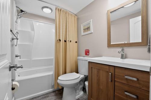 a bathroom with a toilet and a sink and a shower at Steps to Sand Updated Bouchee Beachy Condo Deck Parking in Brigantine