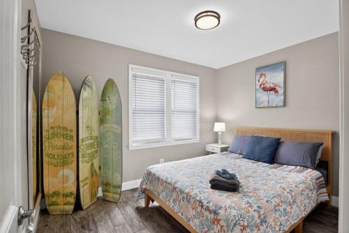 a bedroom with surfboards leaned up against the wall at Radiant Beach Block Condo Parking Patio in Brigantine