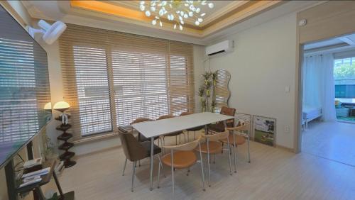 a dining room with a table and chairs at Daegu-station 동성로 GoodLuck STAY in Daegu