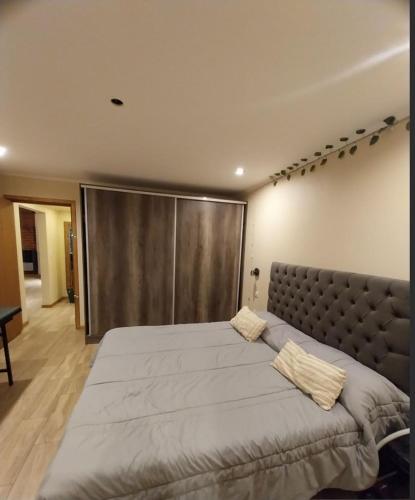 a bedroom with a large bed with a metal door at Encanto serrano in Sierra de los Padres