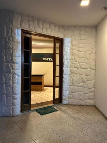a door in a room with a hotel sign on it at DLUX Hotel in Campos dos Goytacazes