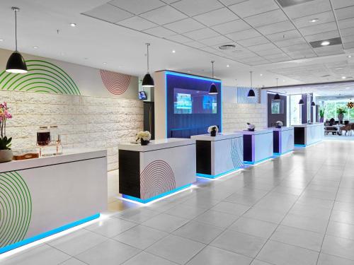 a lobby of a dental office with blue and white counters at Novotel London West in London