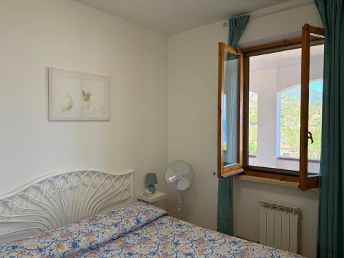 a bedroom with a bed and a window at Villa Marina primo piano in Rio Marina