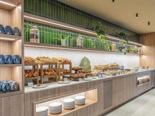 a bakery with many different types of pastries on display at Novotel Lisboa in Lisbon