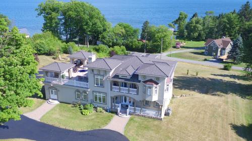 an aerial view of a large house on the water at Riverview B&B in Gananoque