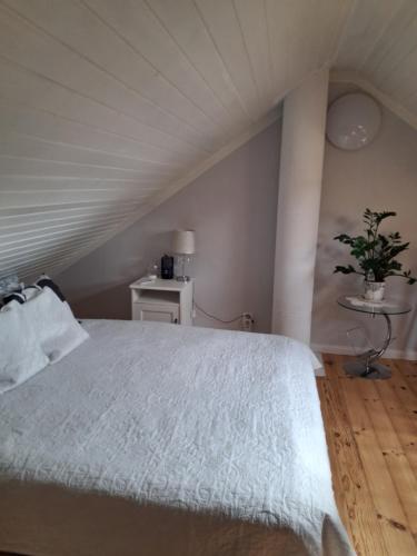 a bedroom with a bed with a white comforter at Villa Aili in Pärnu