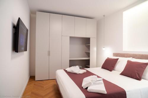a bedroom with a large bed with white cabinets at Appartamento Bianca in Letojanni