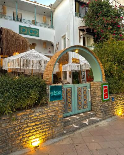 a building with an arch over a stone wall at Andoya Butik Pansiyon in Bodrum City