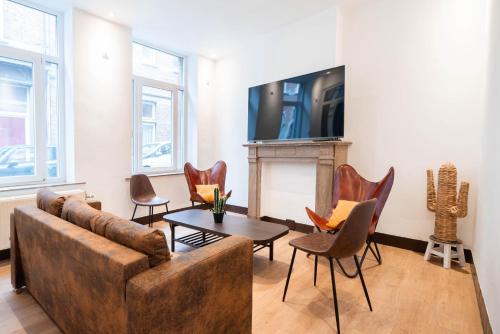 a living room with a couch and chairs and a fireplace at Le West - Dinant Centre in Dinant
