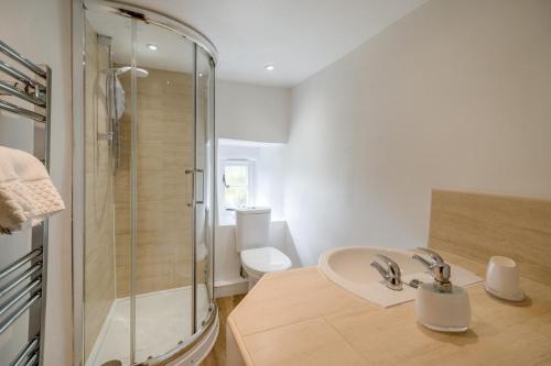a bathroom with a shower and a sink and a toilet at 3 Bed in Askrigg oc-ds926 in Askrigg