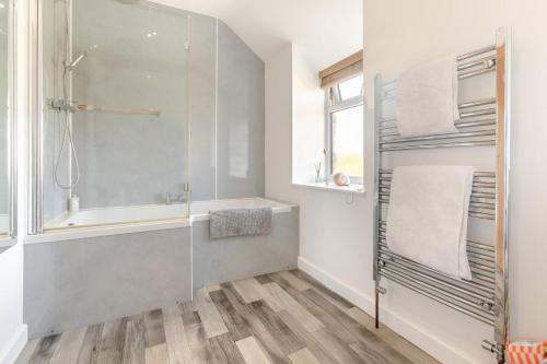 a bathroom with a shower and a bath tub at 1 Bed in Penzance oc-78517 in Newlyn