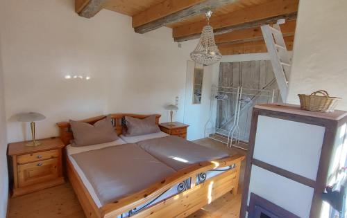 a bedroom with a bed with a wooden frame at Vacation apartment Stüble in Aichstetten