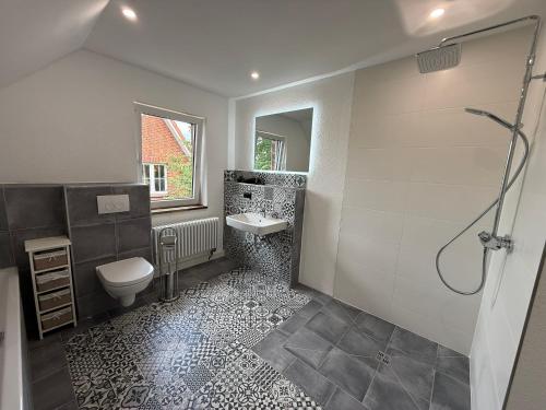 a bathroom with a toilet and a sink and a shower at Ferienhaus Anna in Winsen