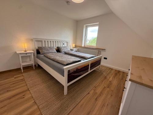 a bedroom with a bed and a window in it at Ferienhaus Anna in Winsen