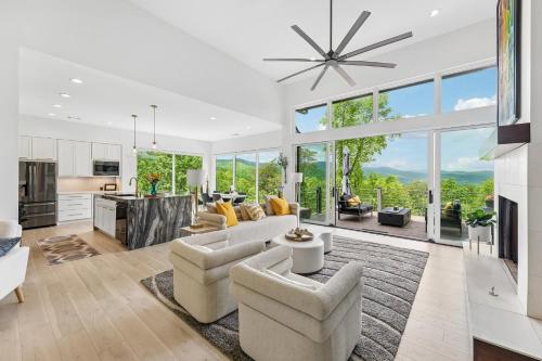 a living room with a couch and chairs and a kitchen at Casa del Sueño - Big Canoe, GA - Take a Dip in the Private Swim Spa, Rack Up a Game of Pool, and Stay Active in the In-Home Fitn in Afton
