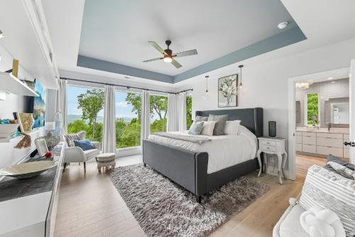 a bedroom with a bed and a living room at Casa del Sueño - Big Canoe, GA - Take a Dip in the Private Swim Spa, Rack Up a Game of Pool, and Stay Active in the In-Home Fitn in Afton