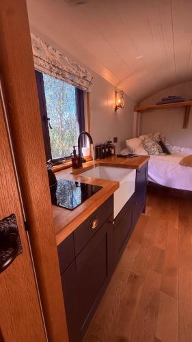 a kitchen with a sink and a bed in a room at Oakwood Marina in Northwich