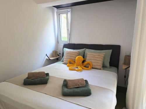 a bed with an octopus sitting on top of it at Kalamea Apartment Kalathas in Kalathas