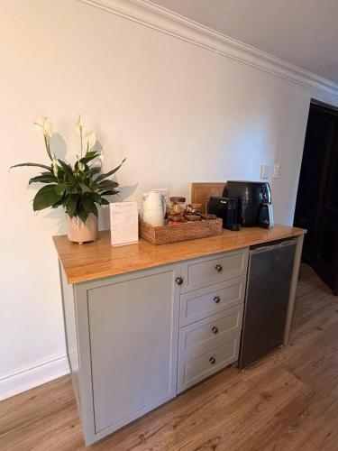 a counter with a table with a plant on it at 22 Emoyeni Drive in Hillcrest