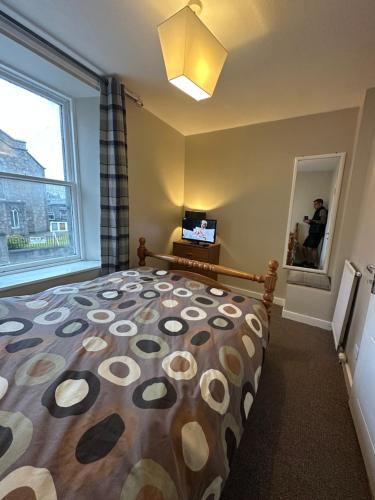 a bedroom with a large bed with a large window at The Staging Post in Aberdeen
