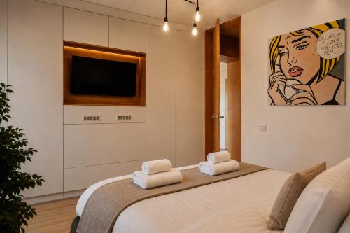 a bedroom with a large bed with towels on it at RHUM B03 - Dome View in Bucharest