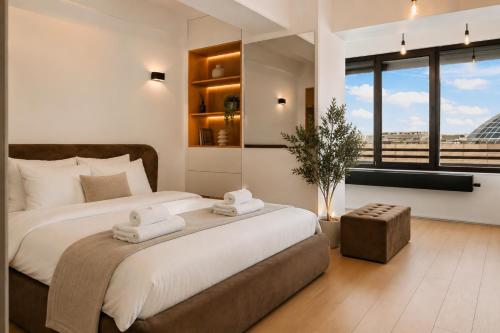 a bedroom with a large bed with two towels at RHUM B03 - Dome View in Bucharest