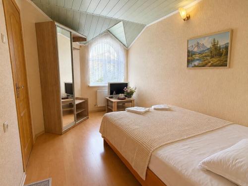 a bedroom with a bed and a television in it at Готель Українське in Vinnytsya