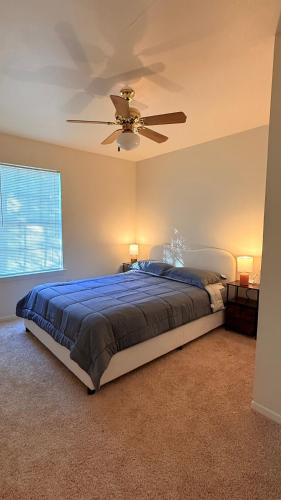 a bedroom with a bed with a ceiling fan at My apartment in Georgetown 2 Bedroom in Georgetown