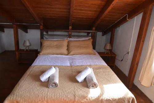 a bed with two rolled up towels on it at Nonna Sofia in Krikellos