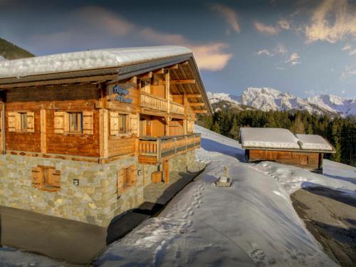 a log cabin in the snow with snow on the ground at Pralor Le Peille - OVO Network in Manigod