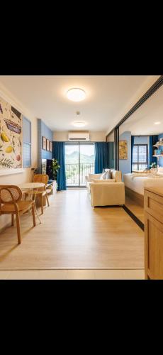 a living room with a couch and a bed and a table at Luxury Designer Studio Sealy Bed Coffee Bar Walk to Cicada Market & Beach in Hua Hin