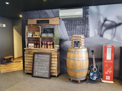 a store with a barrel and a sign and a guitar at ibis Montpellier Centre Polygone in Montpellier