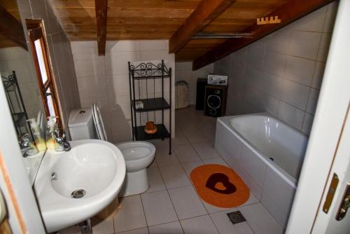 a bathroom with a sink and a tub and a toilet at Nonna Sofia in Krikellos
