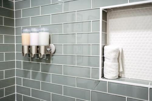 a bathroom with blue tiled walls and a towel at Acacia Retreat by Rather Be Properties in Palm Springs